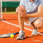 Injured athlete receiving medical attention on field - akd law